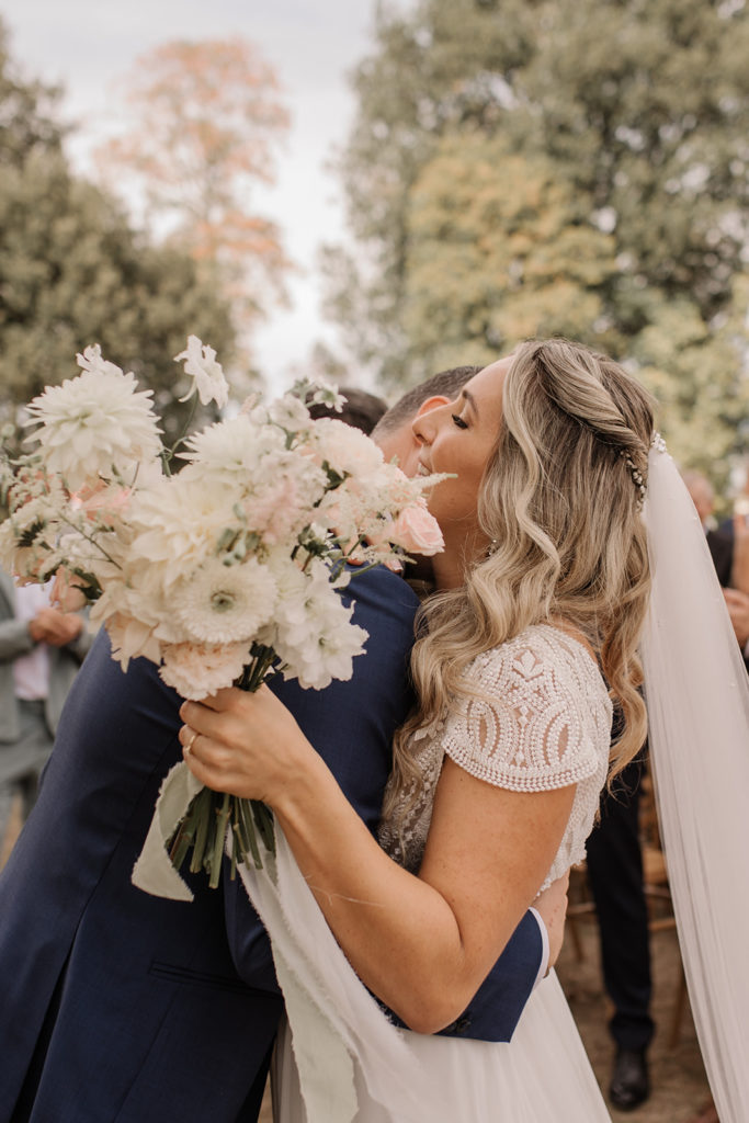 groom hugging his awesome bride